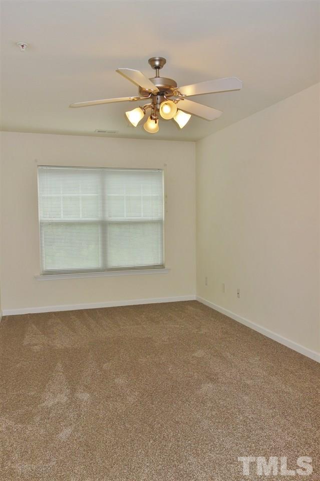 2225 Raven Road, Unit 105 Raleigh, NC 27614 - Photo 13 of 16 an empty room with a chandelier fan and window