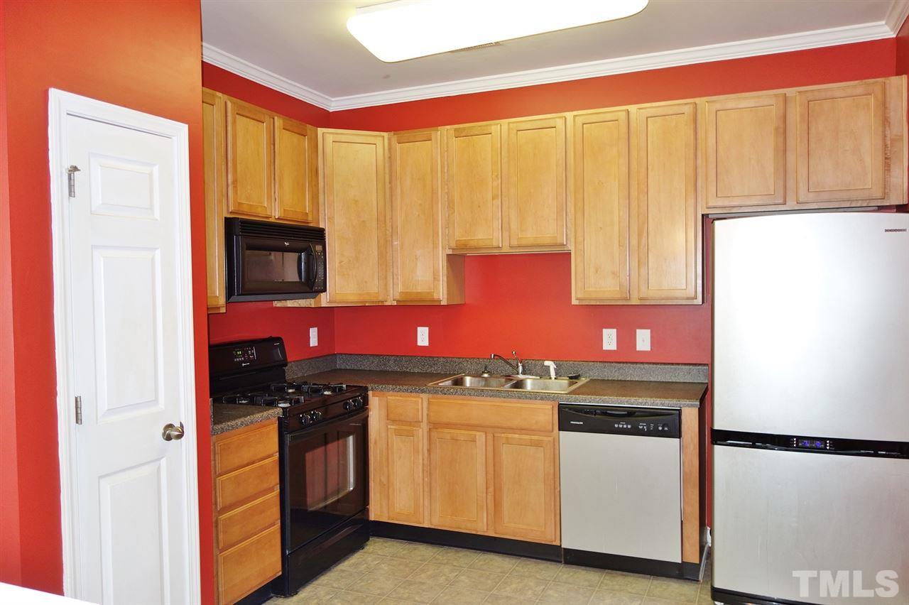 2225 Raven Road, Unit 105 Raleigh, NC 27614 - Photo 5 of 16 a kitchen with stainless steel appliances granite countertop a stove a sink and a microwave