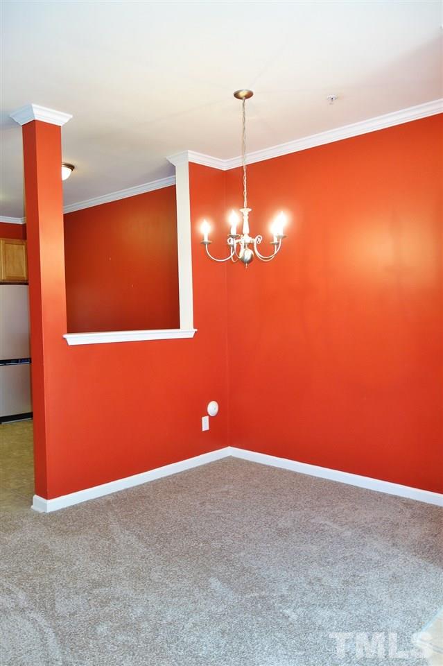 2225 Raven Road, Unit 105 Raleigh, NC 27614 - Photo 6 of 16 a view of an empty room with a chandelier fan