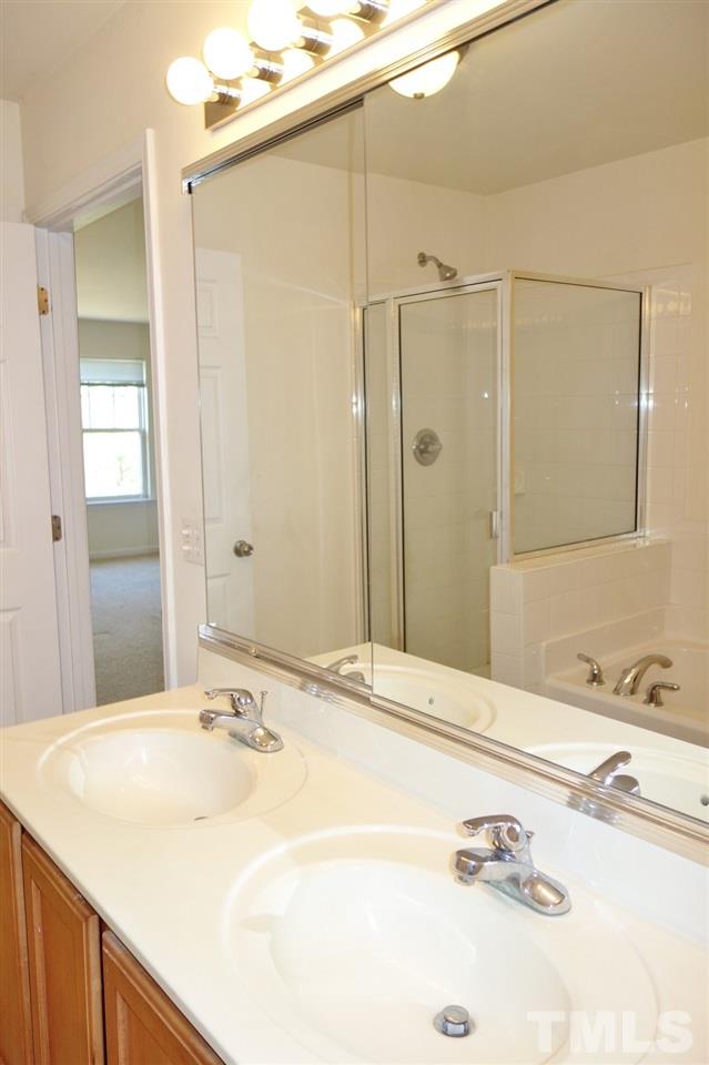2225 Raven Road, Unit 105 Raleigh, NC 27614 - Photo 9 of 16 a bathroom with a sink and a mirror