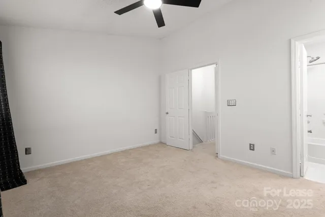 an empty room with view of a bathroom