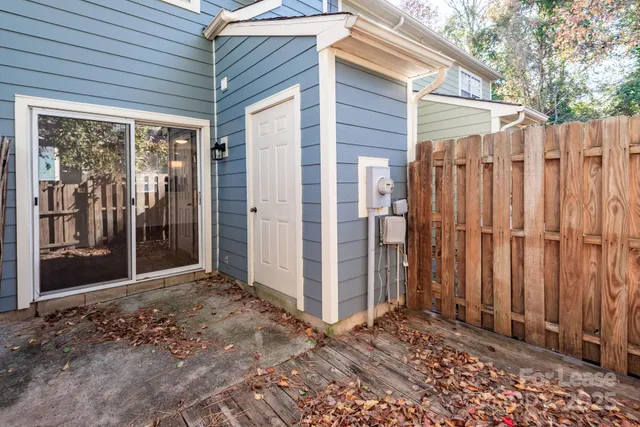 a view of a backyard with wooden fence