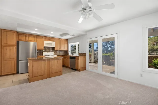 a kitchen with refrigerator a sink and cabinets