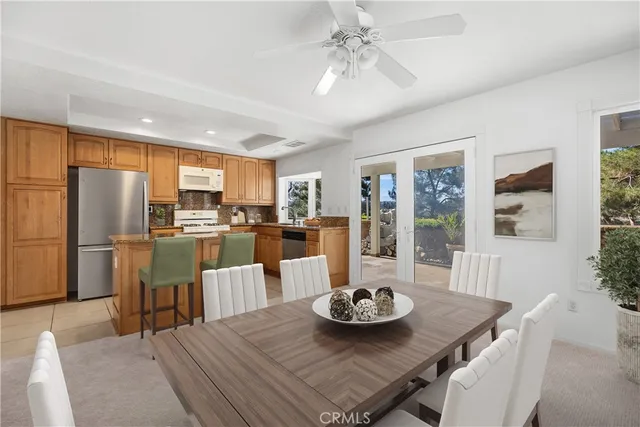 a living room with stainless steel appliances kitchen island granite countertop furniture and a dining table