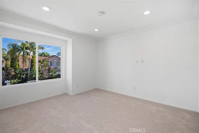a view of a big room with window and tree