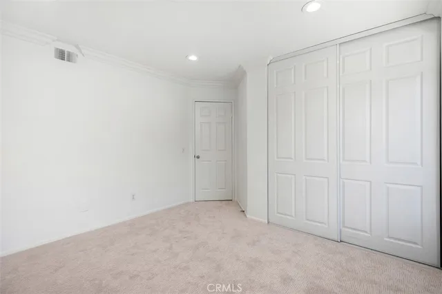 a view of empty room with window and wall painting