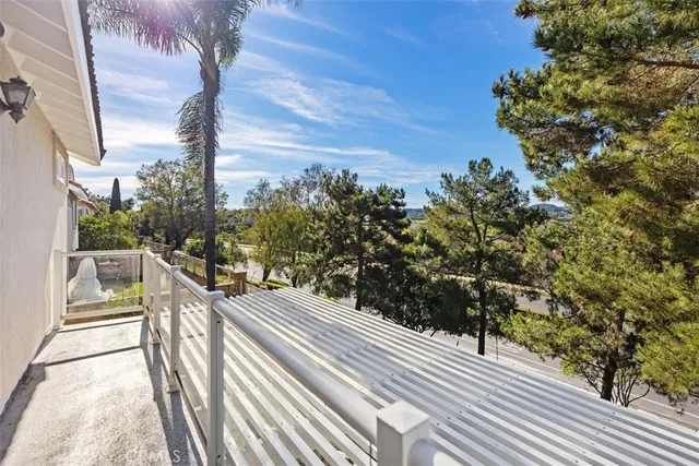 a view of a balcony with wooden stairs