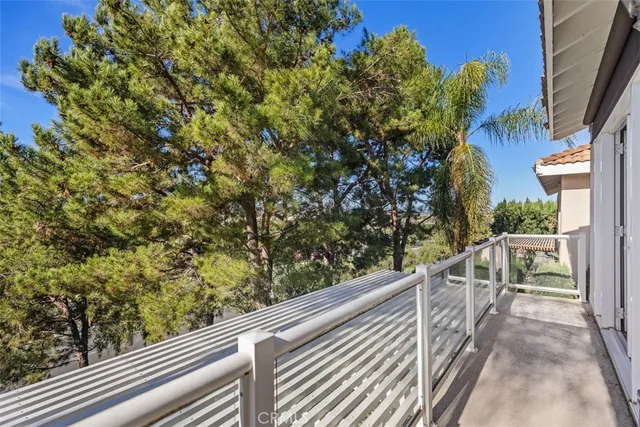 a view of a yard with plants and wooden fence