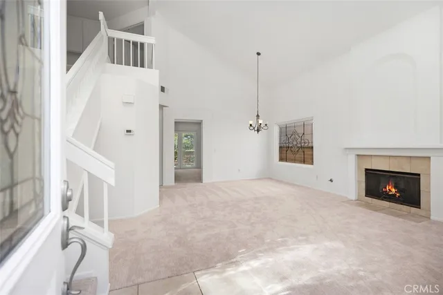 a view of a livingroom with a fireplace and window