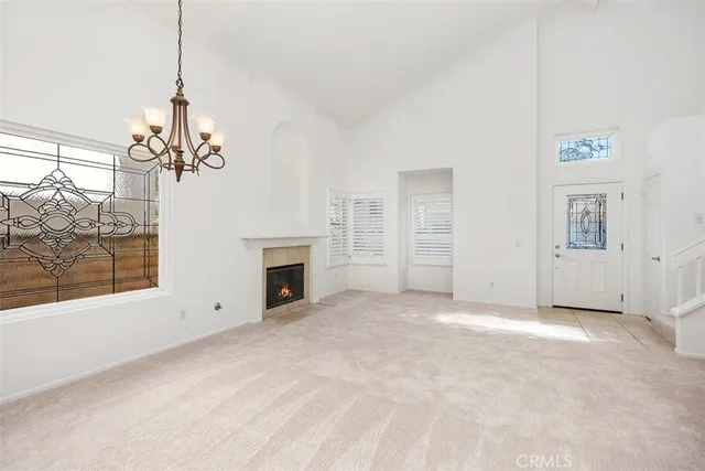 a view of a livingroom with an empty space and a fireplace
