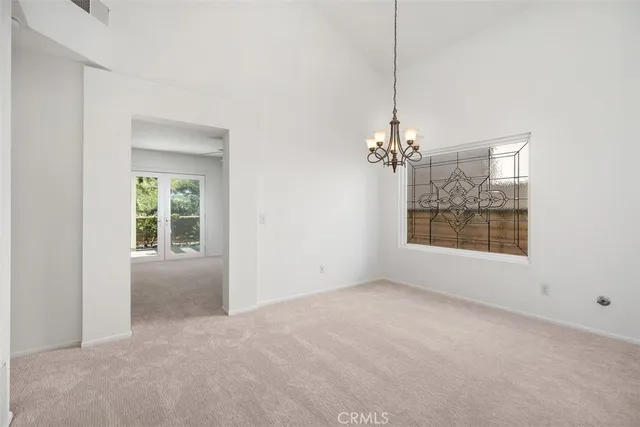 a view of a room with windows and chandelier