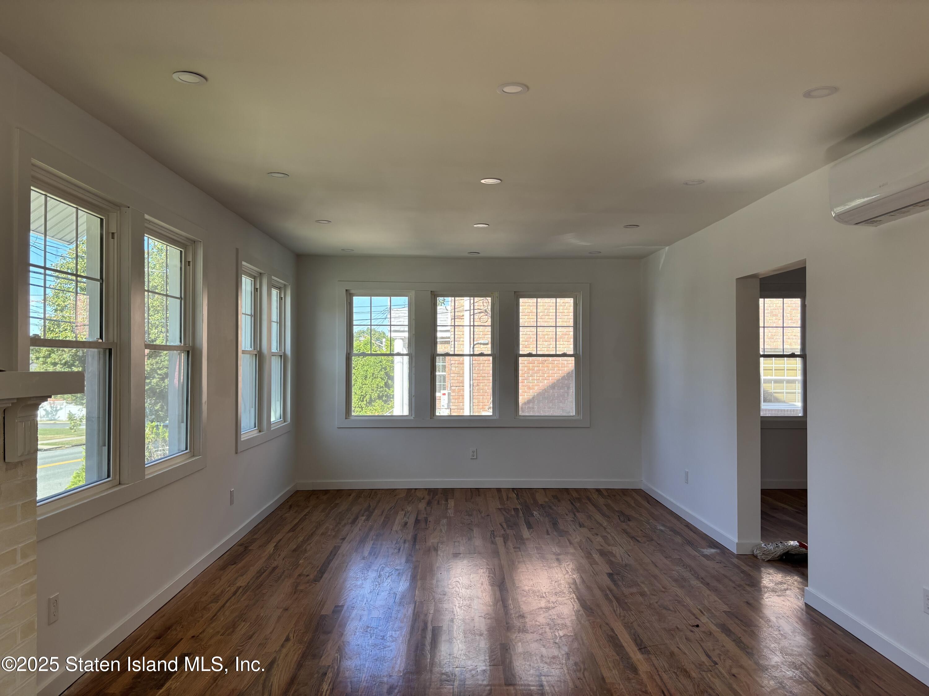 677 Bement Avenue Staten Island, NY 10310 - Photo 4 of 37 a view of an empty room with wooden floor and a window
