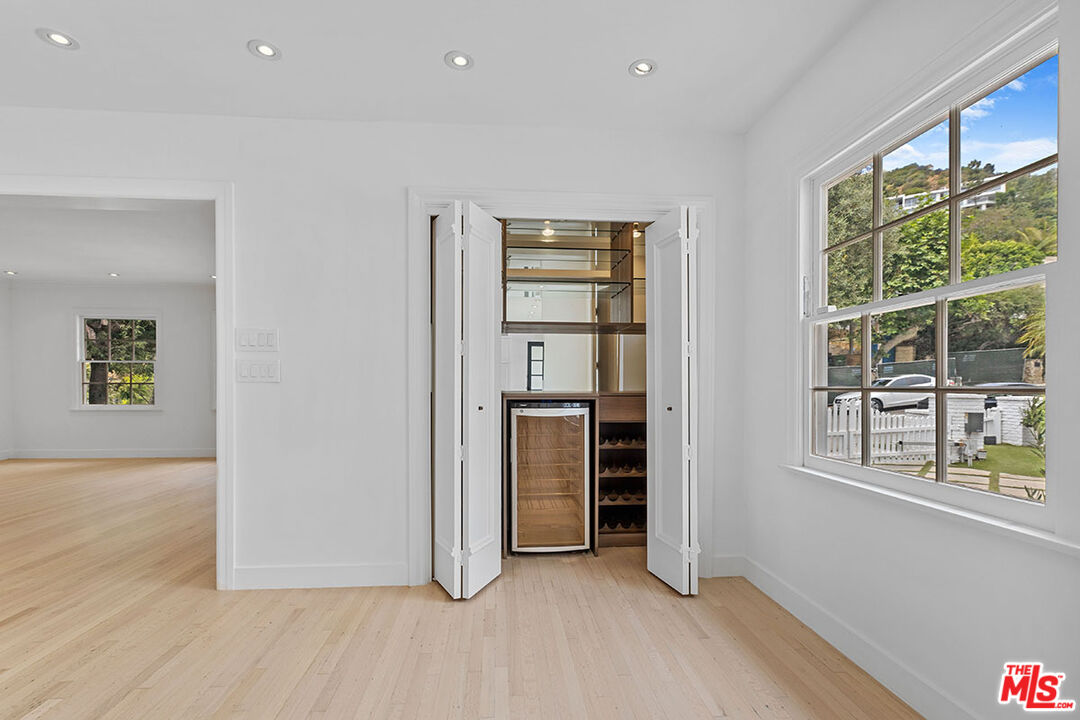 1462 Rising Glen Road Los Angeles, CA 90069 - Photo 19 of 40 wooden floor in an empty room with a window