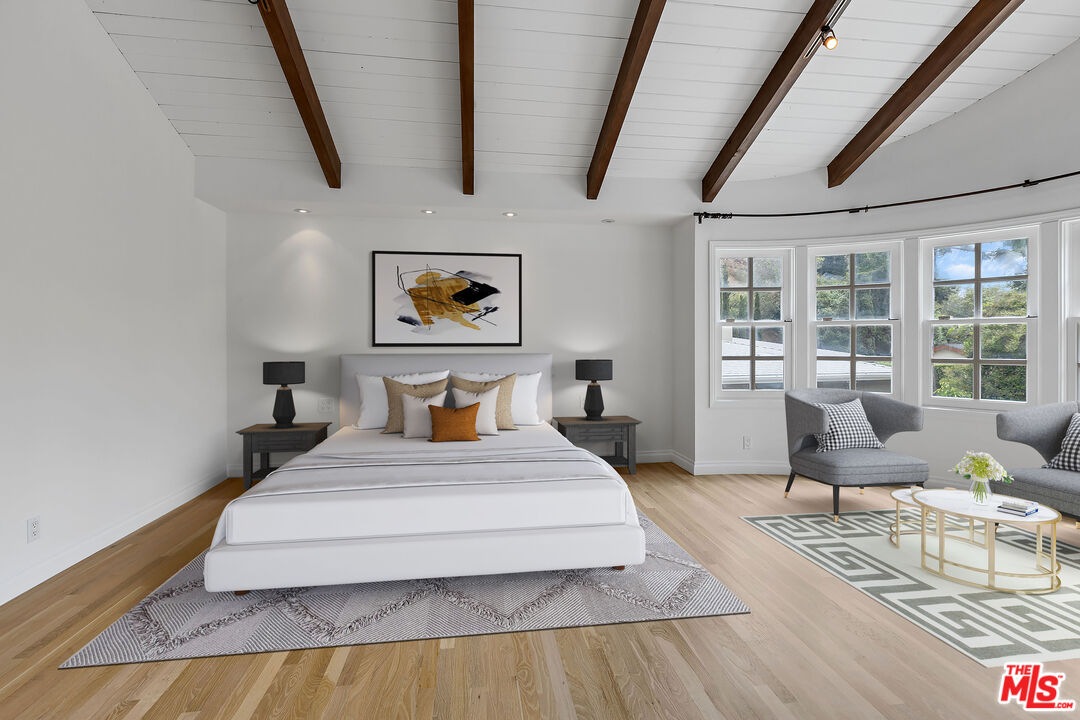 1462 Rising Glen Road Los Angeles, CA 90069 - Photo 21 of 40 a bedroom with a bed and glass walk in closet