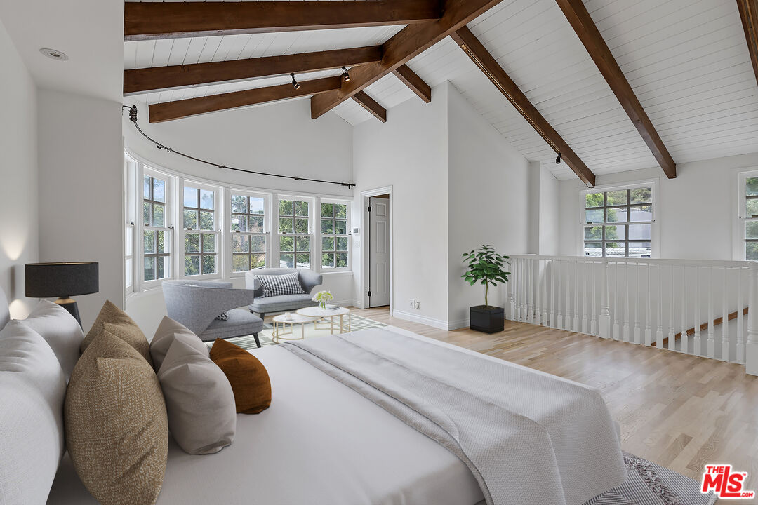 1462 Rising Glen Road Los Angeles, CA 90069 - Photo 22 of 40 a bedroom with a large bed and a large window