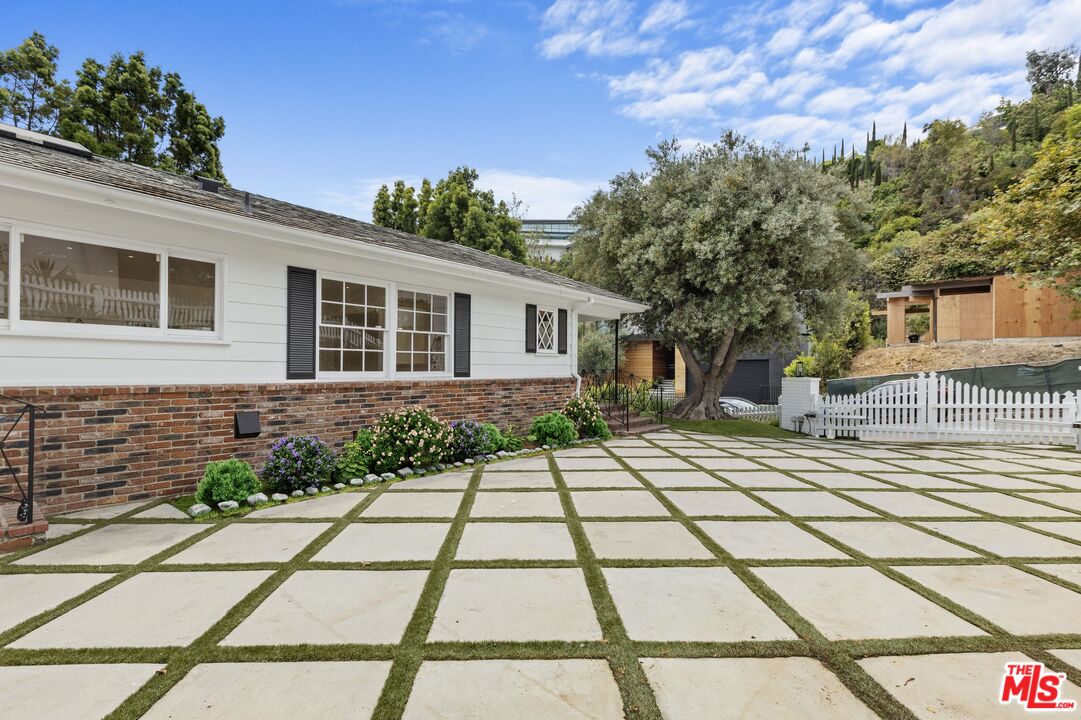 1462 Rising Glen Road Los Angeles, CA 90069 - Photo 3 of 40 a front view of a house with a garden