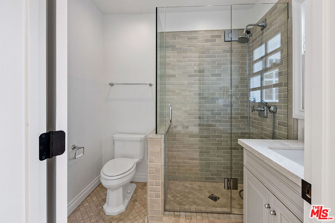 1462 Rising Glen Road Los Angeles, CA 90069 - Photo 37 of 40 a bathroom with a shower and a toilet