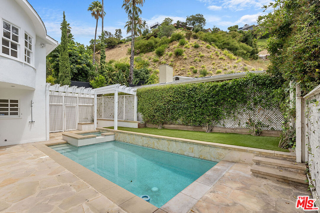 1462 Rising Glen Road Los Angeles, CA 90069 - Photo 40 of 40 a view of a house with a swimming pool