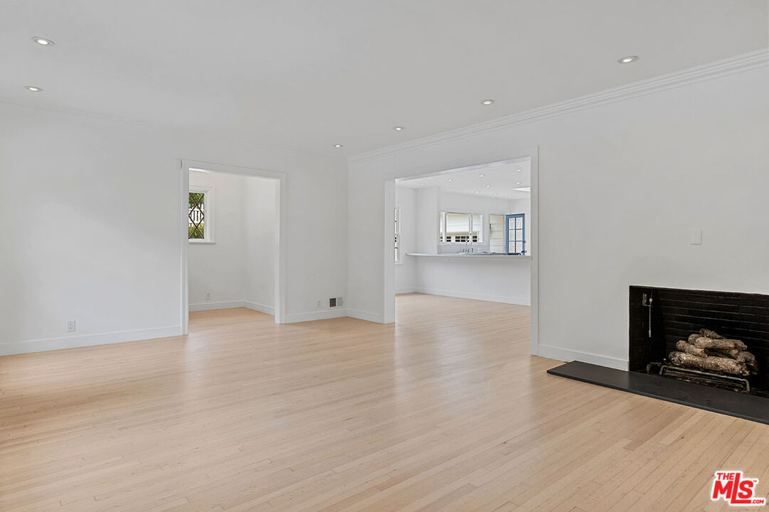 1462 Rising Glen Road Los Angeles, CA 90069 - Photo 7 of 40 a view of a livingroom with wooden floor and a flat screen tv