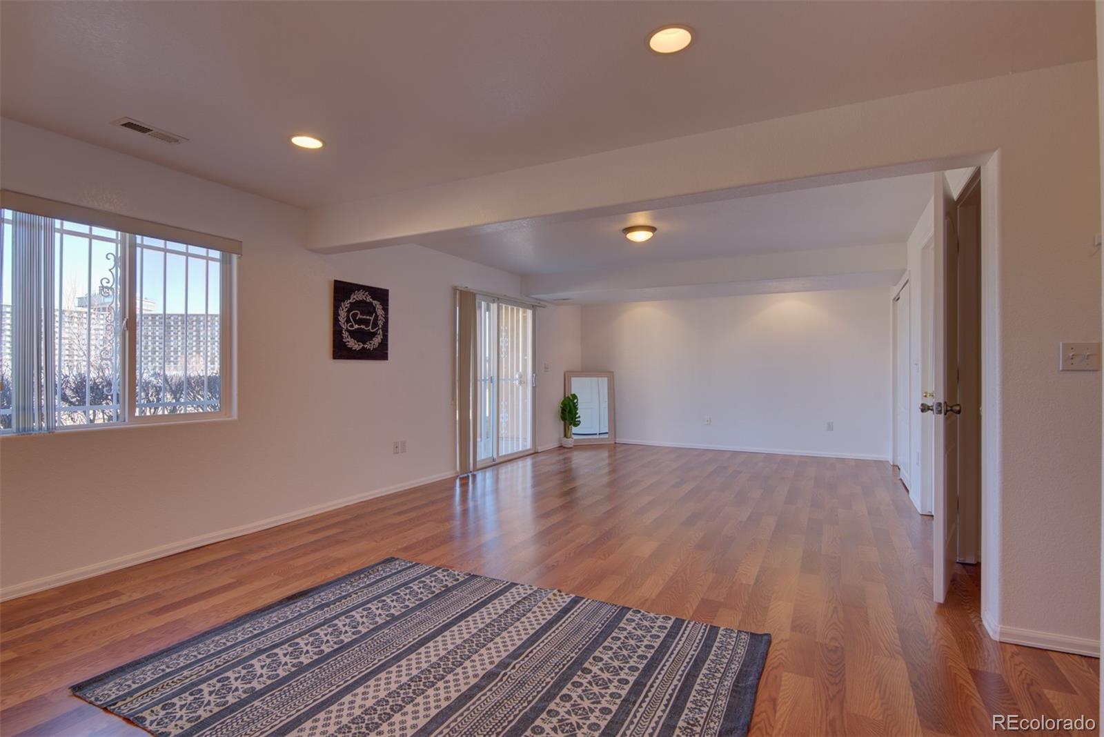 3563 Indigo Ridge Point Colorado Springs, CO 80910 - Photo 17 of 28 a view of an empty room with wooden floor and a window