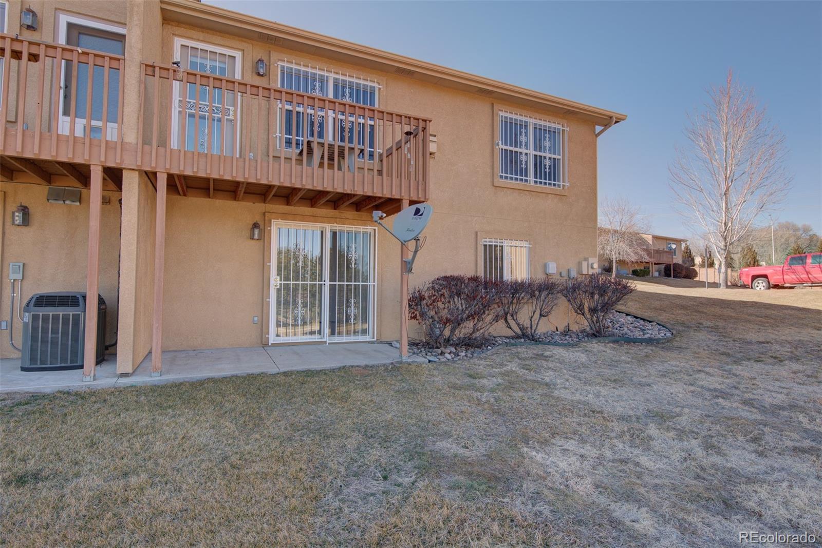 3563 Indigo Ridge Point Colorado Springs, CO 80910 - Photo 27 of 28 a view of a house with backyard and porch