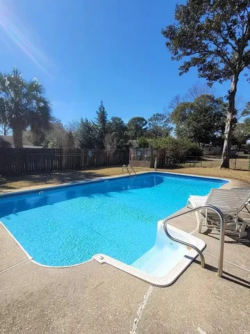 a view of a swimming pool and lounge chair