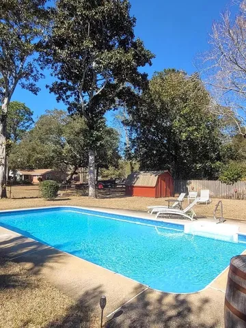a view of a swimming pool with a yard