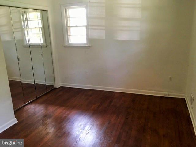 8506 Schultz Road Clinton, MD 20735 - Photo 13 of 30 an empty room with wooden floor and windows