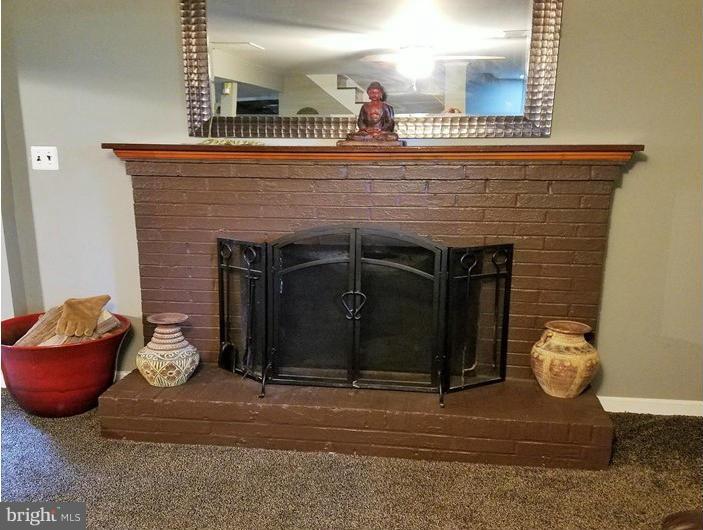 8506 Schultz Road Clinton, MD 20735 - Photo 17 of 30 a living room with furniture and a fireplace