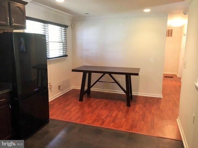 8506 Schultz Road Clinton, MD 20735 - Photo 8 of 30 a view of an empty room with wooden floor and a window