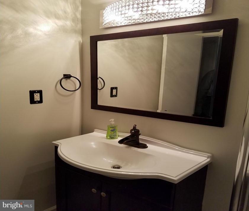 8506 Schultz Road Clinton, MD 20735 - Photo 10 of 30 a bathroom with a sink and a mirror