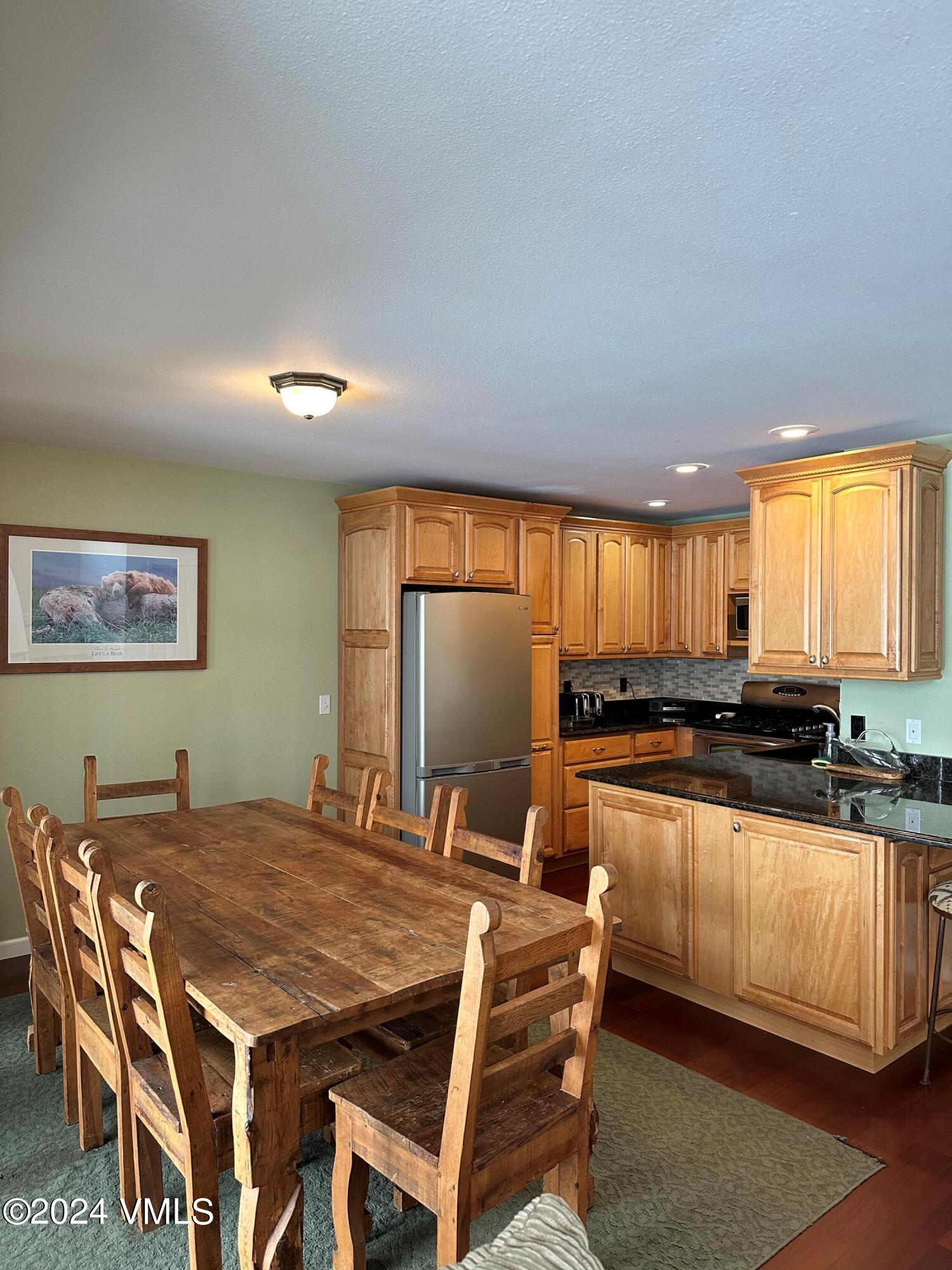 8 Red Tail Drive Edwards, CO 81632 - Photo 3 of 9 a kitchen with stainless steel appliances granite countertop a stove a sink a refrigerator a dining table and chairs