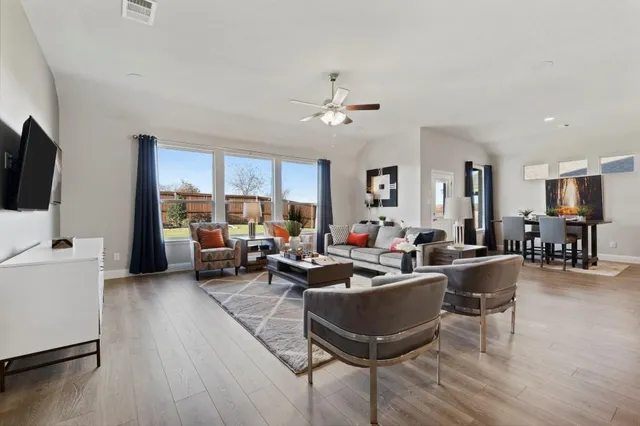a living room with furniture or kitchen view and a wooden floor