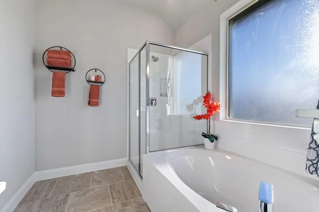 a bedroom with a bed dresser and window