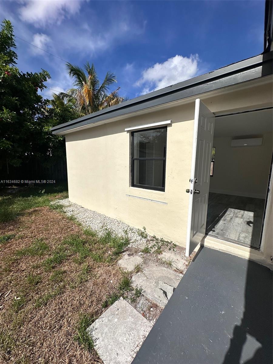 6517 Wiley Street Hollywood, FL 33023 - Photo 11 of 17 a front view of a house with a yard