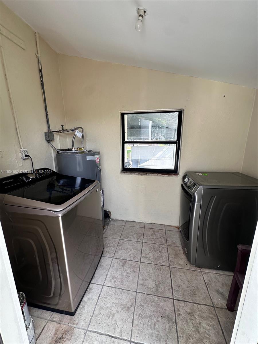 6517 Wiley Street Hollywood, FL 33023 - Photo 12 of 17 a kitchen with a stove top oven and cabinets
