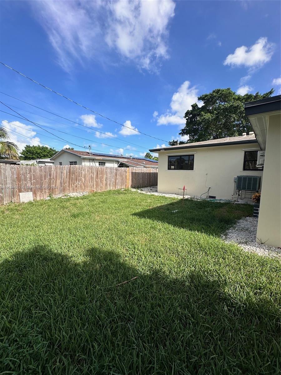 6517 Wiley Street Hollywood, FL 33023 - Photo 14 of 17 a view of a backyard with plants and a lake view