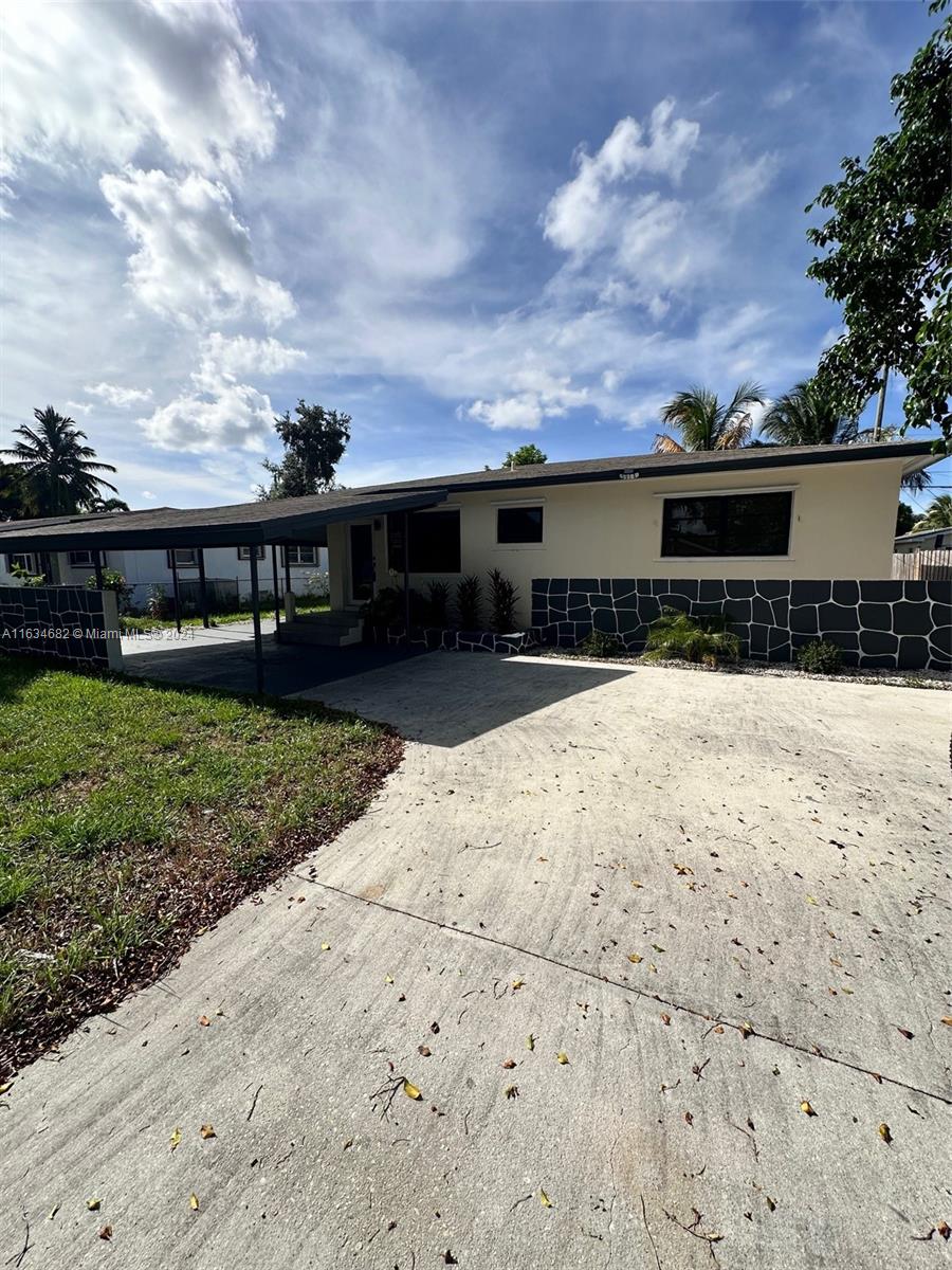 6517 Wiley Street Hollywood, FL 33023 - Photo 17 of 17 a front view of house with yard covered in the background