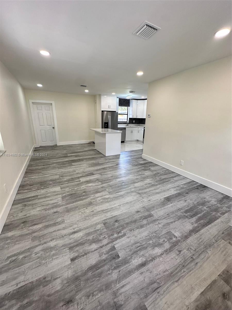 6517 Wiley Street Hollywood, FL 33023 - Photo 2 of 17 a view of kitchen and hall with wooden floor