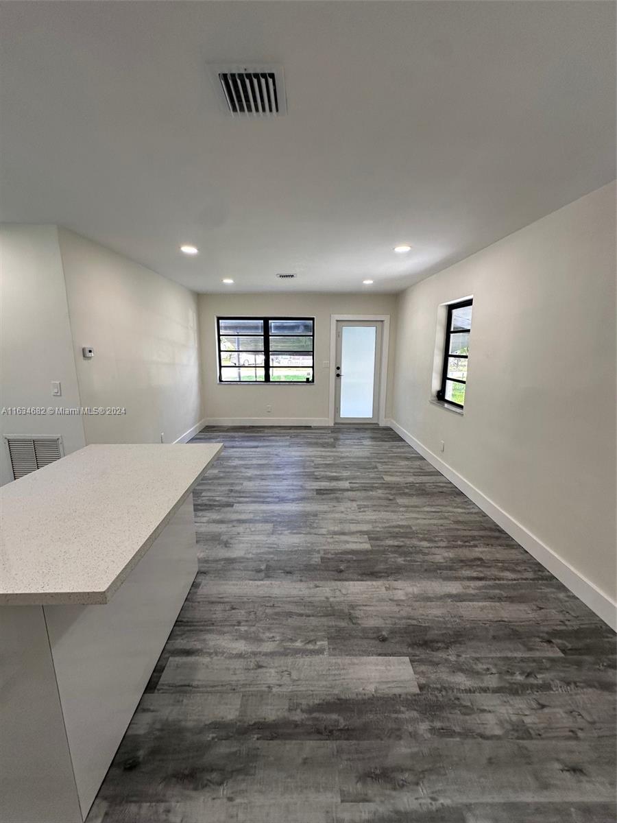 6517 Wiley Street Hollywood, FL 33023 - Photo 3 of 17 a spacious bedroom with a bed and a large window