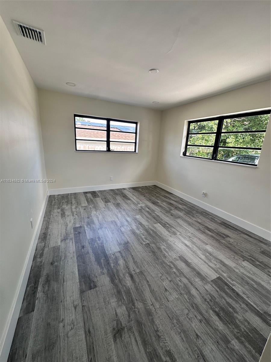 6517 Wiley Street Hollywood, FL 33023 - Photo 7 of 17 wooden floor in an empty room with a window