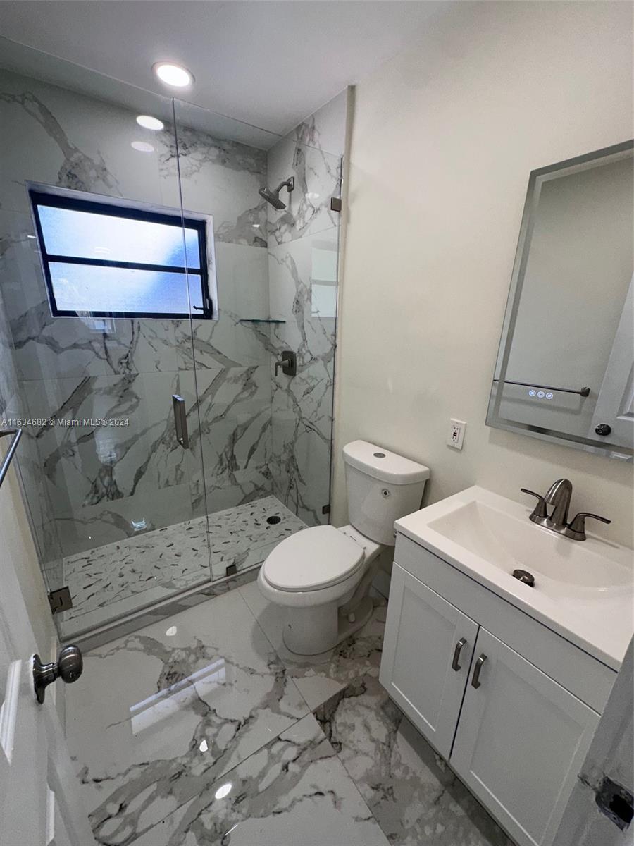 6517 Wiley Street Hollywood, FL 33023 - Photo 8 of 17 a bathroom with a toilet sink and shower