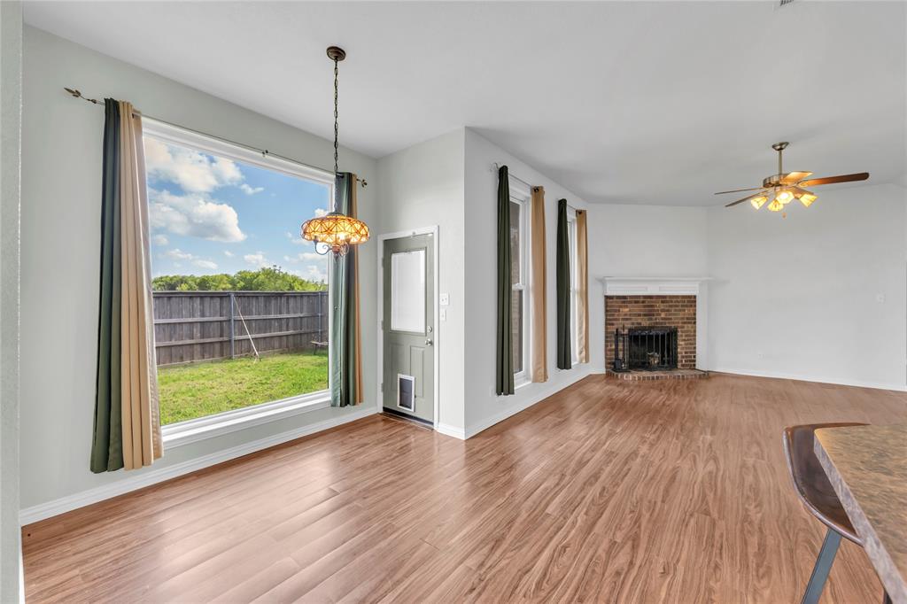 16055 Prairie Meadow Forney, TX 75126 - Photo 13 of 33 a view of empty room with wooden floor and fireplace
