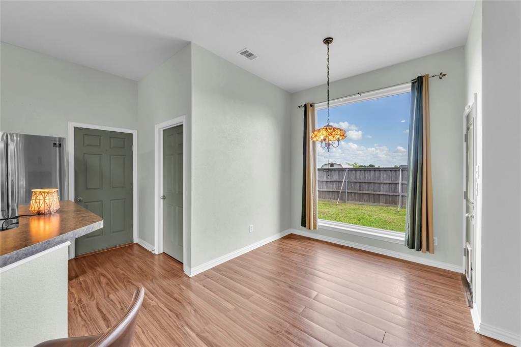 16055 Prairie Meadow Forney, TX 75126 - Photo 17 of 33 a view of a room with wooden floor and a ceiling fan