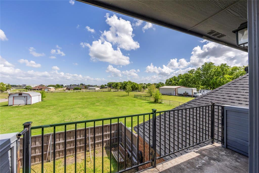 16055 Prairie Meadow Forney, TX 75126 - Photo 21 of 33 a view of a balcony with wooden floor & fence