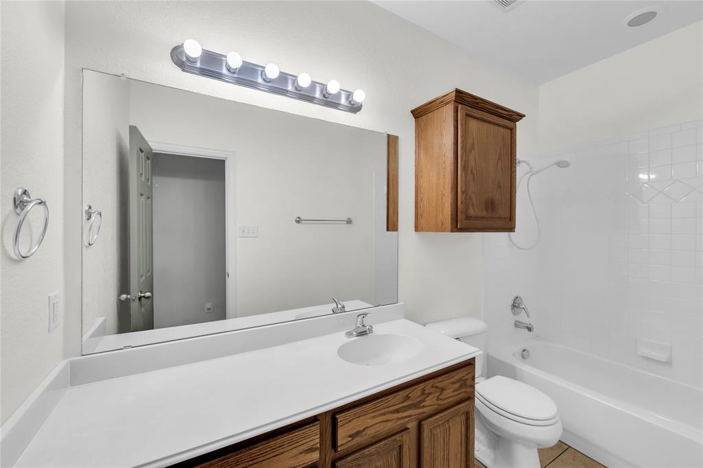 16055 Prairie Meadow Forney, TX 75126 - Photo 25 of 33 a bathroom with a sink a toilet and shower