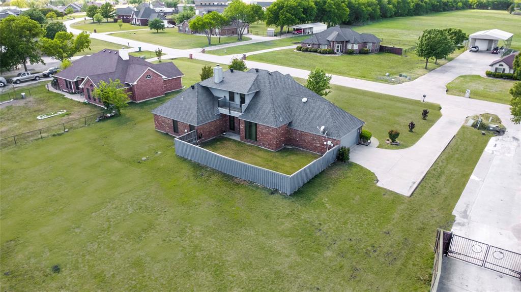 16055 Prairie Meadow Forney, TX 75126 - Photo 30 of 33 an aerial view of a house with swimming pool and a yard