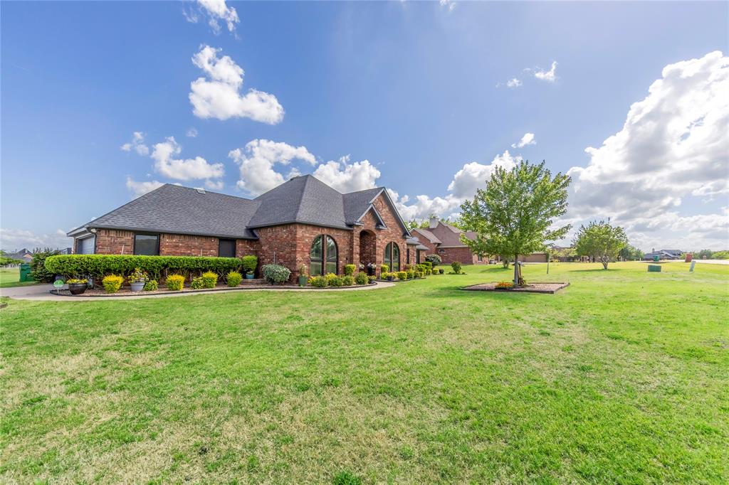 16055 Prairie Meadow Forney, TX 75126 - Photo 3 of 33 a front view of a house with a garden