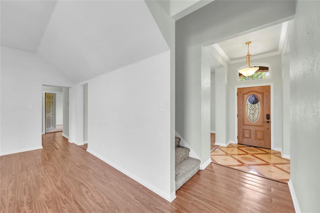 16055 Prairie Meadow Forney, TX 75126 - Photo 6 of 33 a view of a hallway with wooden floor and a bathroom
