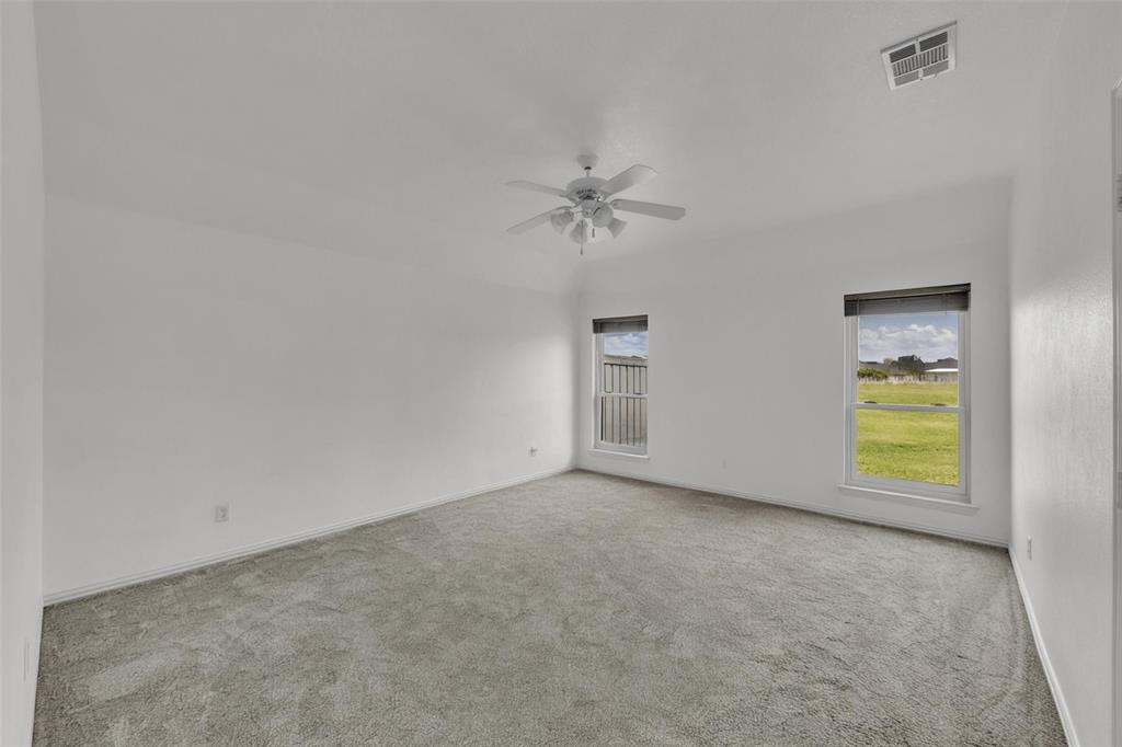 16055 Prairie Meadow Forney, TX 75126 - Photo 8 of 33 an empty room with a stove and ceiling fan